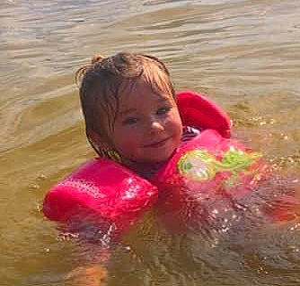 Lilith joined the competition — help win amazing prizes! bathing, body_of_water, child, eye, fun, happy, joy, lake, leisure, lifejacket, ocean, person, personal_protective_equipment, recreation, sea, smile, summer, toddler, vacation, water