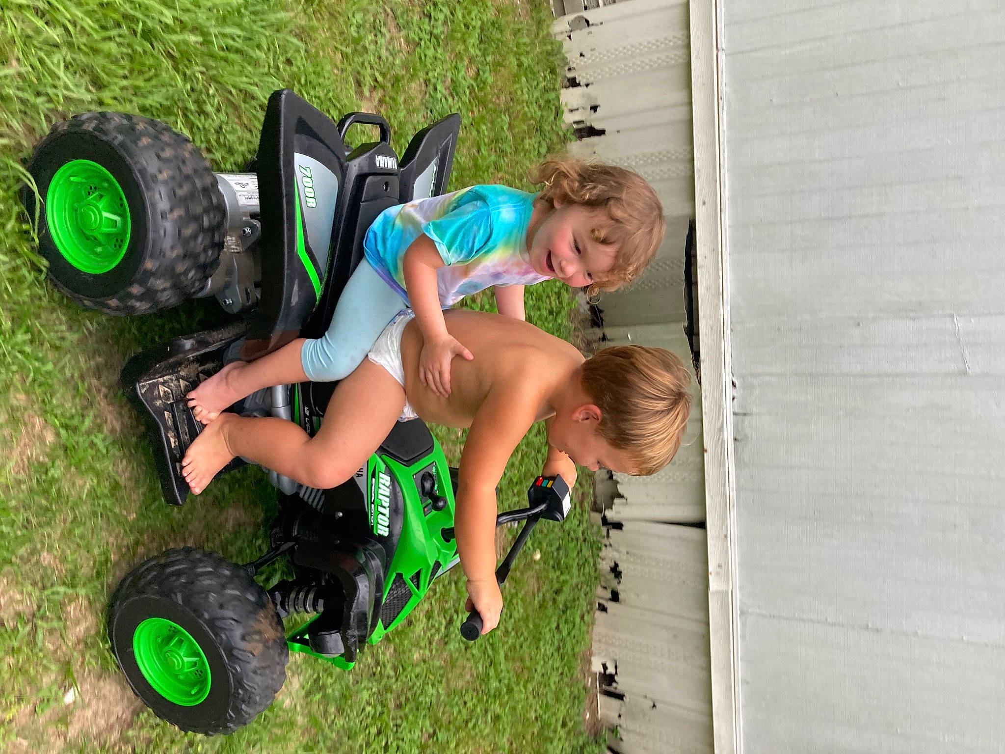 Delilah Evelyn Damron is registered to the contest to win money with this photo: auto_part, automotive_design, automotive_tire, automotive_wheel_system, fun, grass, happy, leisure, motor_vehicle, people_in_nature, person, recreation, rim, rolling, shorts, smile, synthetic_rubber, tire, tread, vehicle