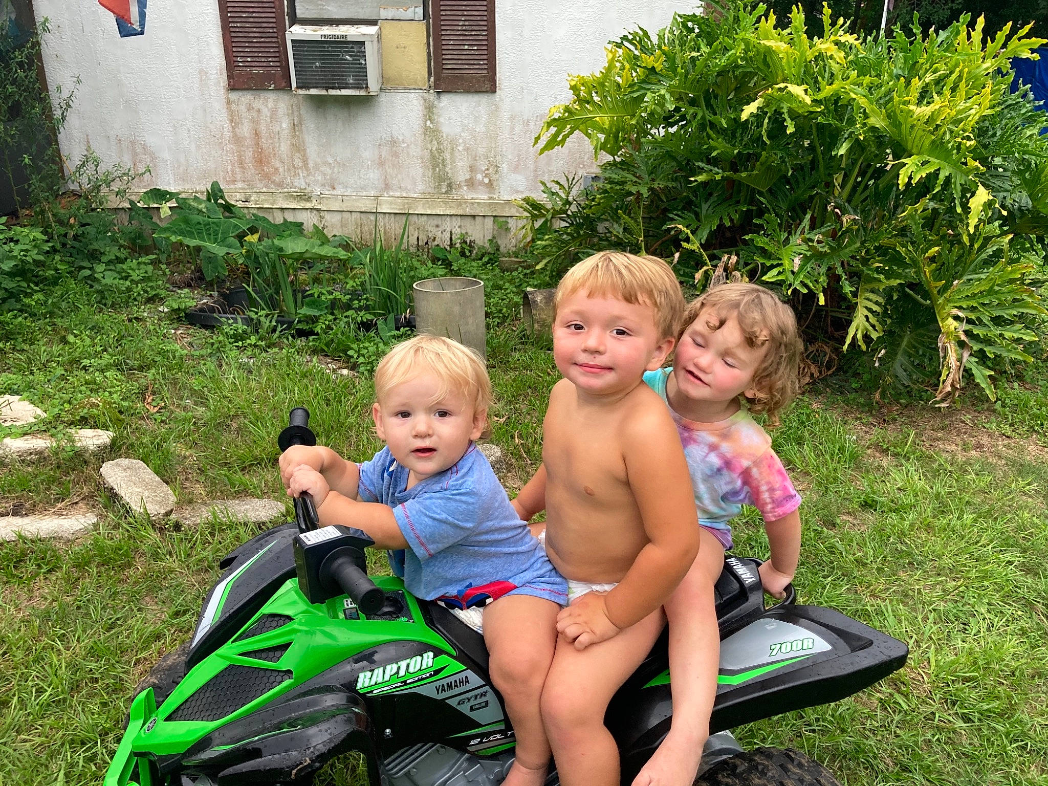 Brantley Damron is registered to the contest to win money with this photo: child, event, flowerpot, fun, garden, grass, grass_family, happy, joy, lawn, leisure, motor_vehicle, people_in_nature, person, plant, recreation, shorts, smile, summer, swimwear