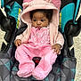 baby, child, pink_clothing, hooded_jacket, car_seat, indoor, infant, cute, cozy, patterned, footed_pajamas, curious, small_hands, black_hair, fabric_texture, seatbelt, soft_material, casual, young, portrait