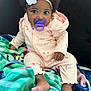 Londyn joined the competition — help win amazing prizes! baby, child, pacifier, headband, flower, afro, pink_onesie, blanket, sitting, indoor, cute, portrait, infant, soft_fabric, colorful, cozy, young_child, baby_clothes, barefoot, curious