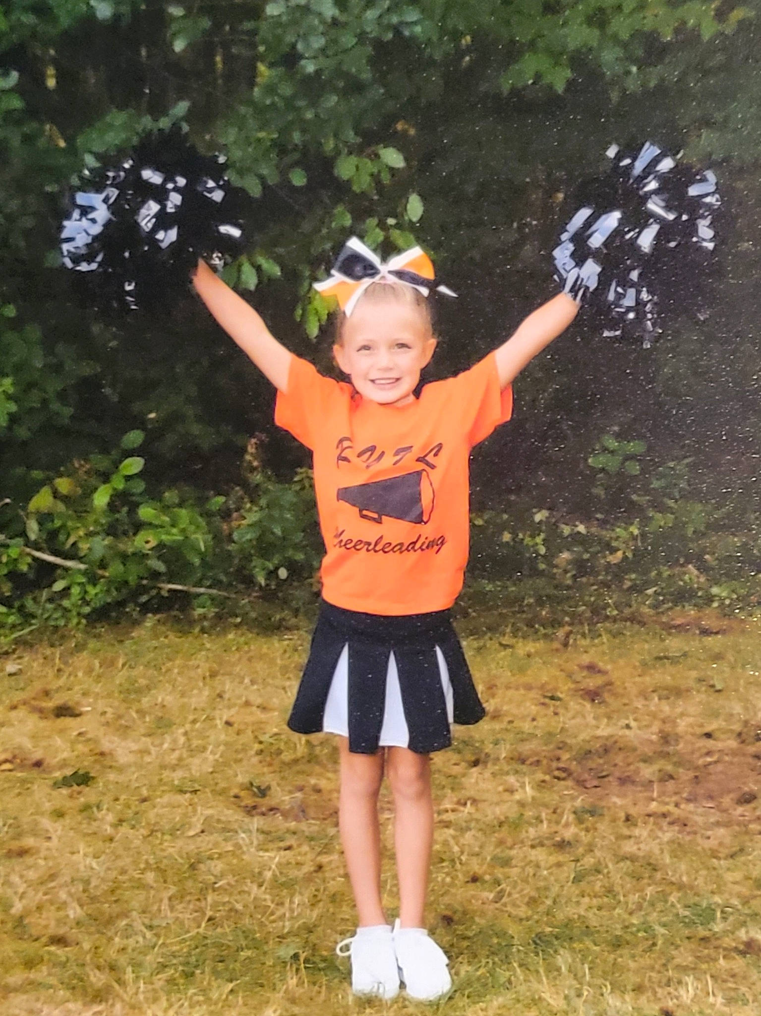 Paisley is registered to the contest to win money with this photo: child, costume, electric_blue, fun, gesture, grass, happy, human_leg, joy, leisure, party_supply, people_in_nature, person, personal_protective_equipment, plant, recreation, smile, t_shirt, toddler, tree