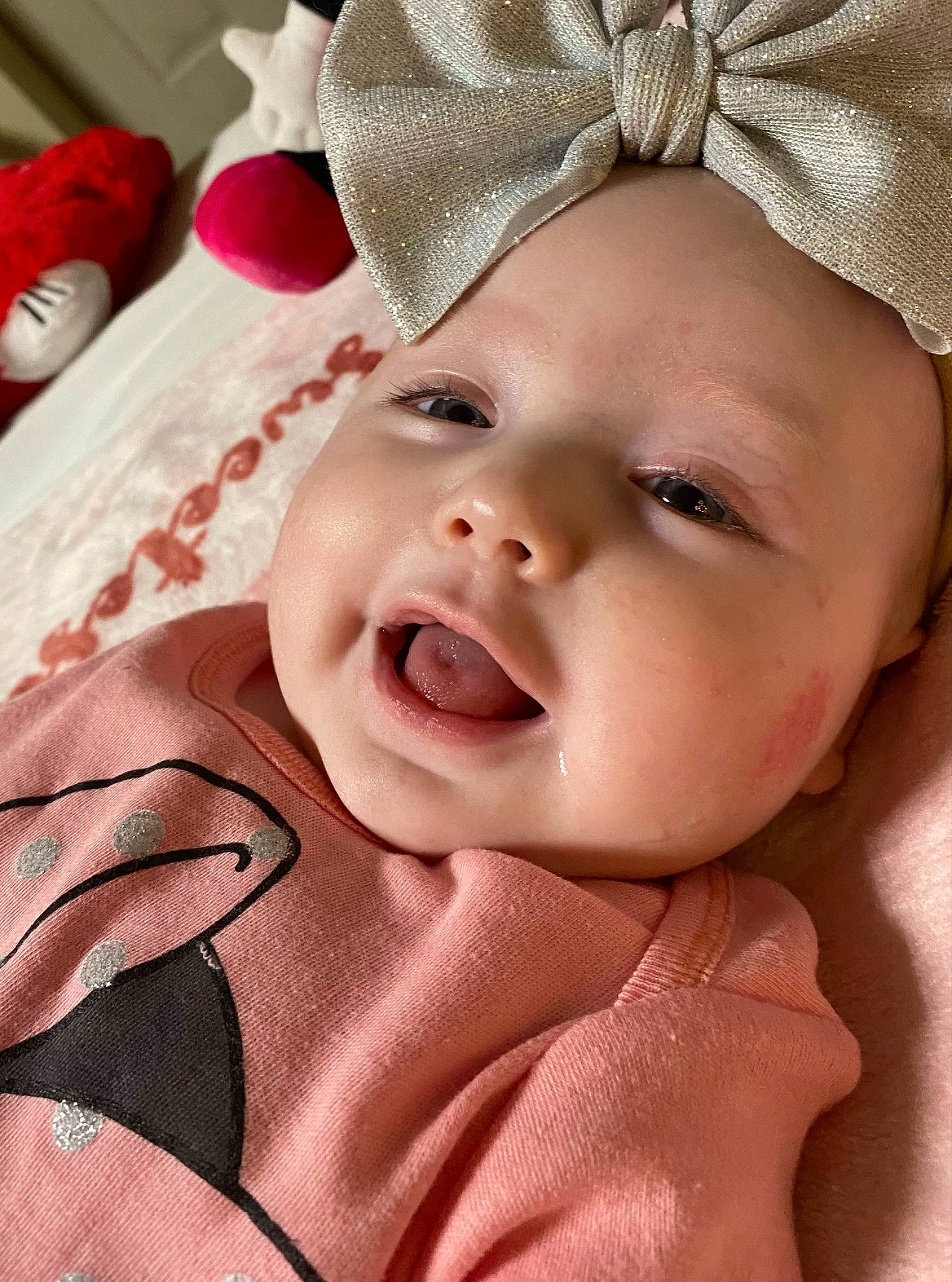 Aleigha is registered to the contest to win money with this photo: baby, cap, cheek, chin, eye, eyebrow, face, gesture, happy, head, human_body, lip, mouth, nose, organ, person, pink, skin, smile, textile