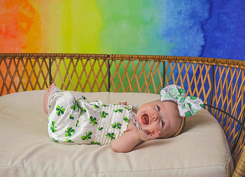 Aleigha is registered to the contest to win money with this photo: art, baby, baby_toddler_clothing, child, comfort, design, grass, happy, hat, human_leg, leisure, linens, magenta, pattern, people_in_nature, person, room, sitting, thigh, toddler