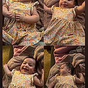 Anaya is registered to the contest to win money with this photo: baby, infant, child, floral_dress, blanket, cozy, smiling, lying_down, cute, portrait, indoors, soft_lighting, happy, playful, toddler, skin, hair, fabric, comfort, expression