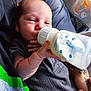 Forest is registered to the contest to win money with this photo: baby, bottle, feeding, milk, infant, hand, tattoo, clothing, person, closeup, indoor, mesh_organizer, medicine, skin, newborn, holding, resting, cute, portrait, babywear