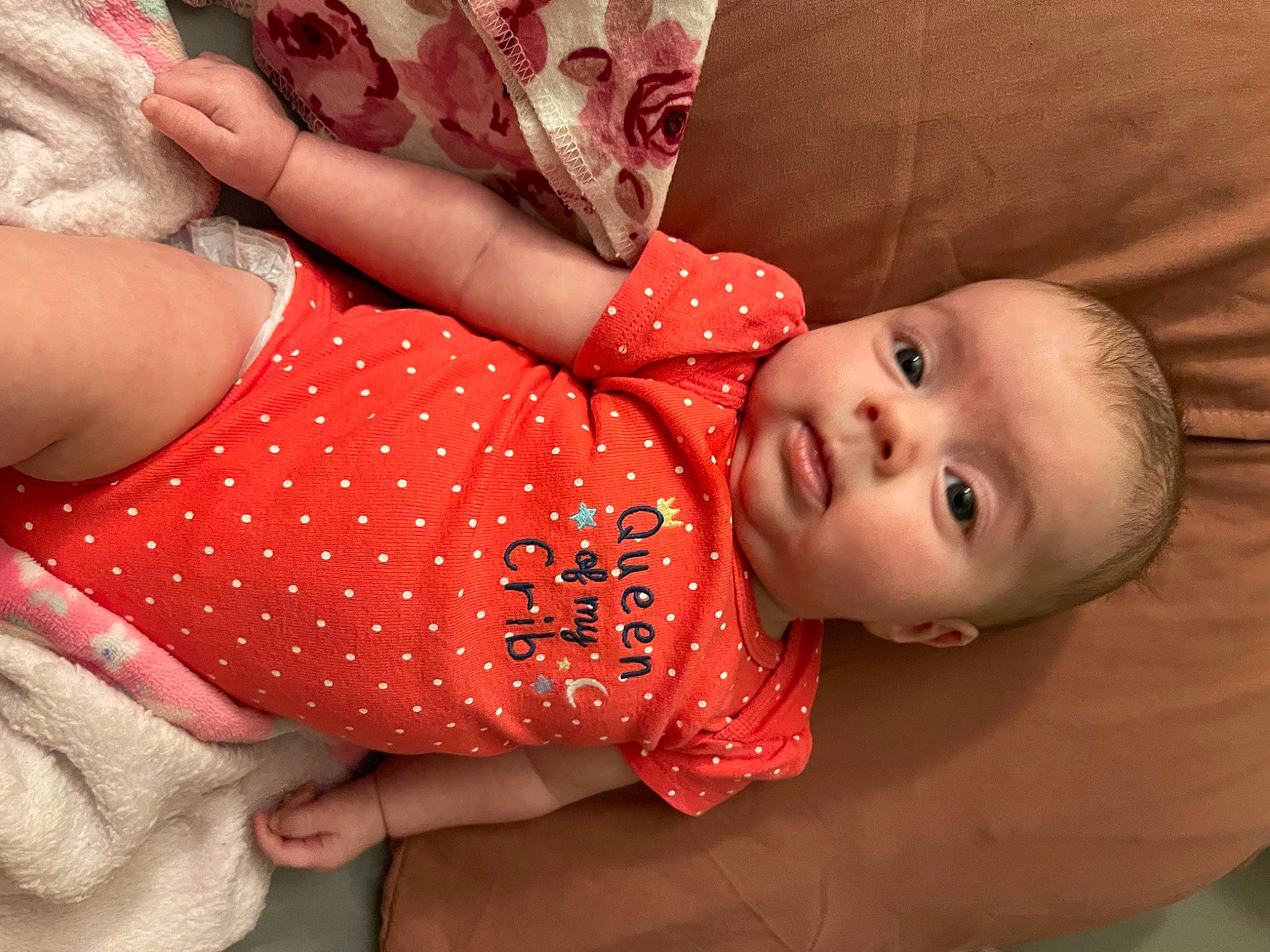 Lorelei is registered to the contest to win money with this photo: baby, baby_toddler_clothing, cheek, chest, finger, hand, happy, human_body, joint, lip, mouth, neck, orange, pattern, person, red, skin, sleeve, textile, thigh