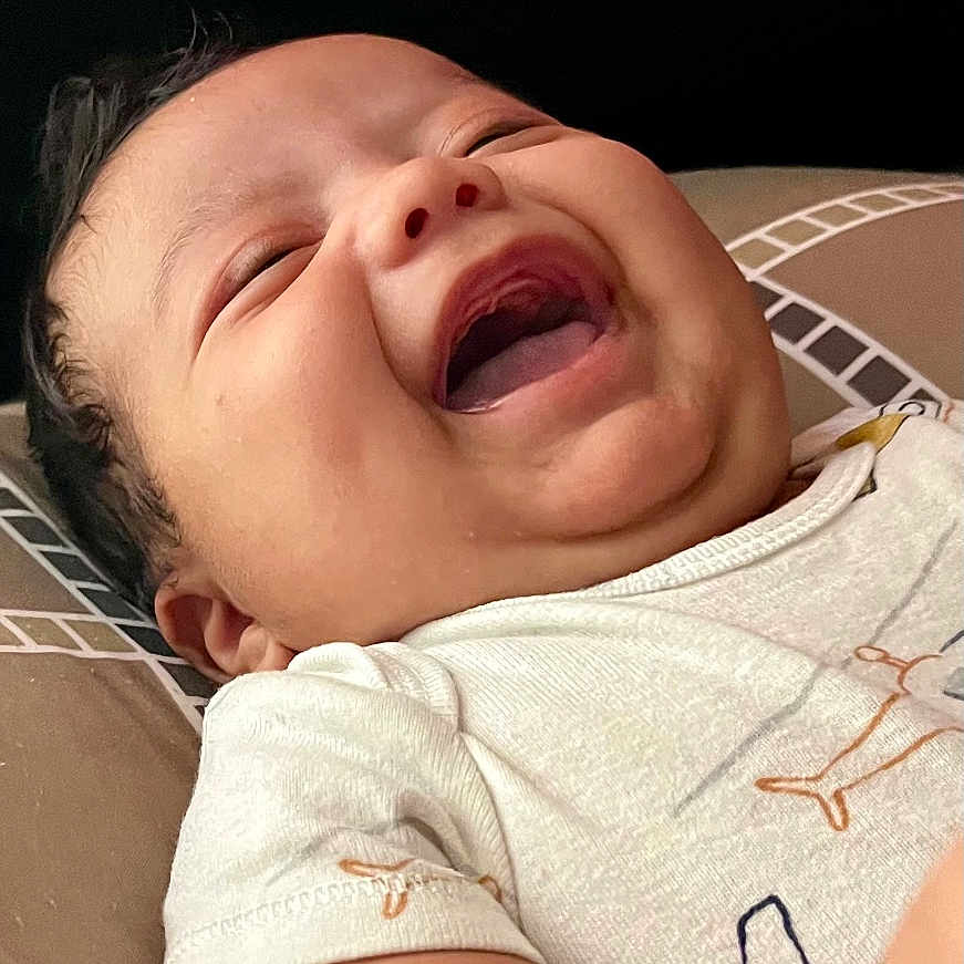 Roilan joined the competition — help win amazing prizes! arm, baby, child, chubby_cheeks, close_up, cushion, cute, expression, face, happy, indoor, infant, joy, laughing, lying_down, pattern, portrait, skin, smile, white_clothing