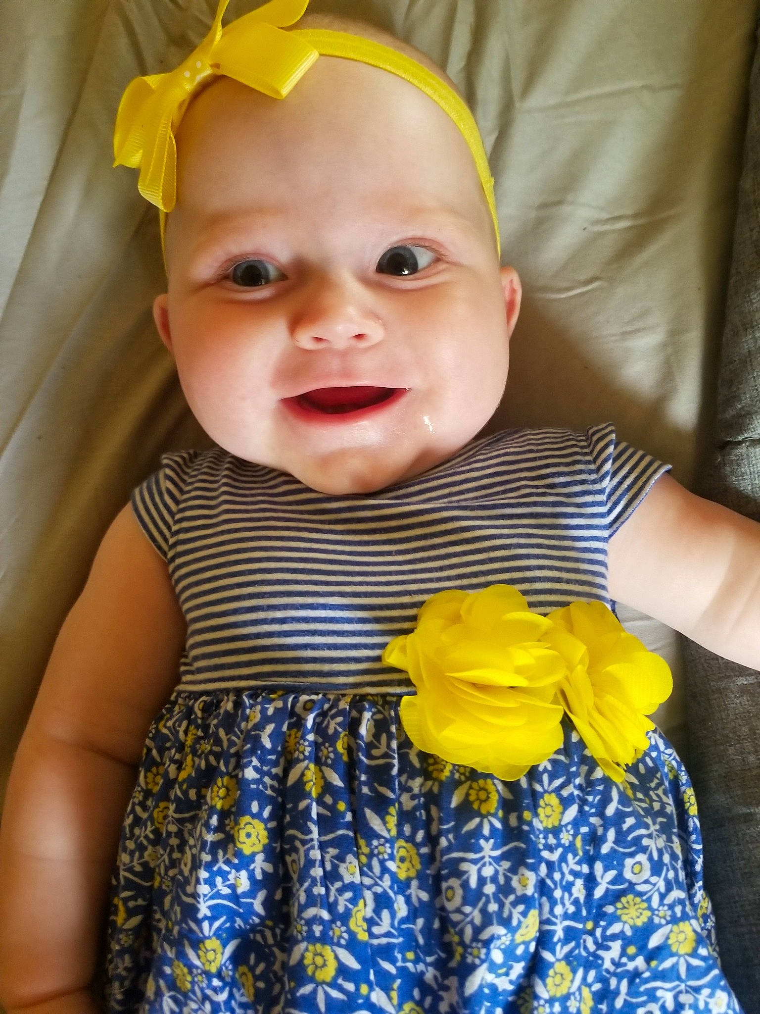 Chevy Cheyenne Marie joined the competition — help win amazing prizes! baby, baby_products, baby_toddler_clothing, cheek, child, dress, eye, face, hair_accessory, head, headband, headgear, iris, pattern, person, skin, smile, textile, toddler, yellow