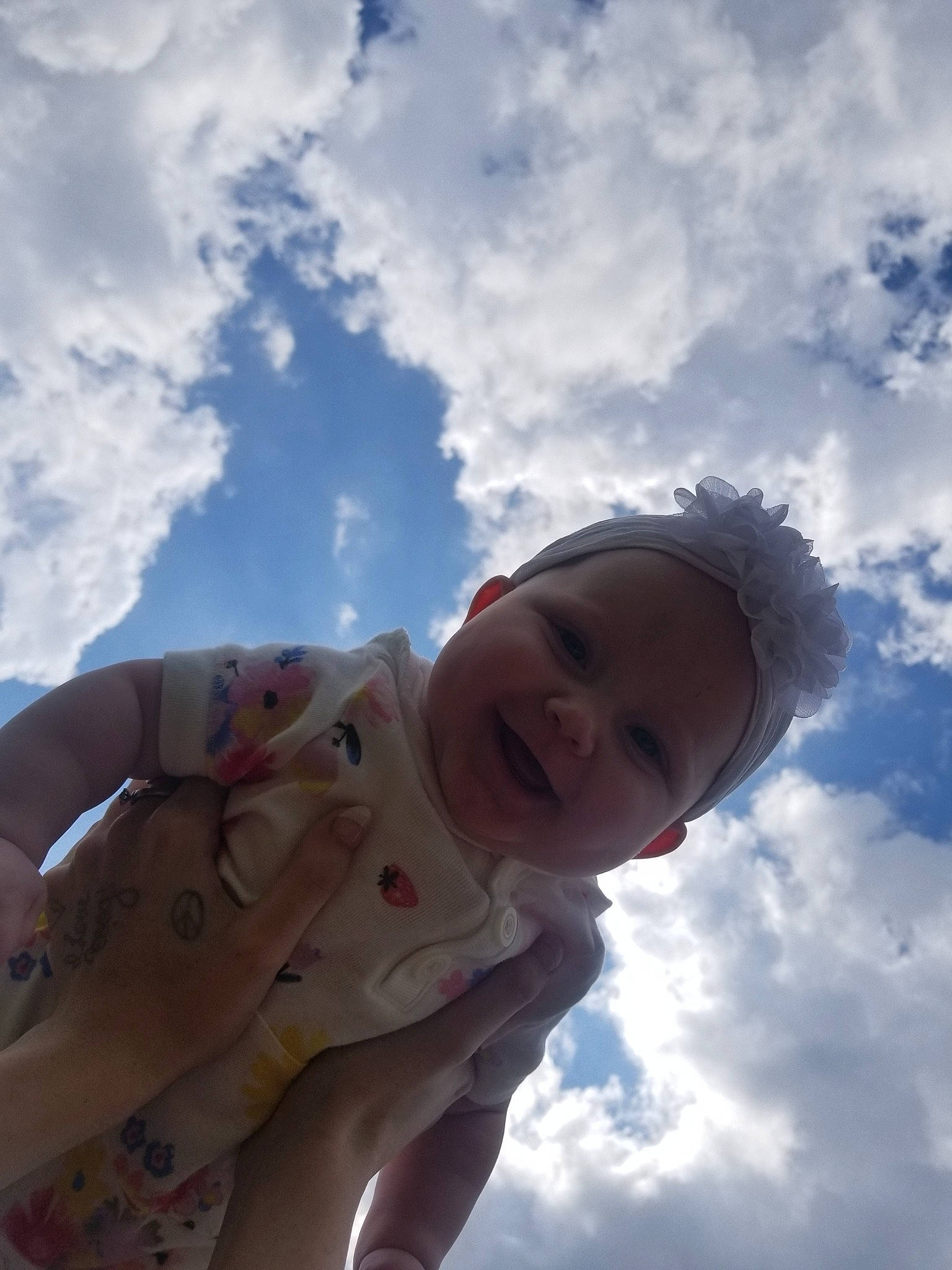 Chevy Cheyenne Marie is registered to the contest to win money with this photo: baby, child, cloud, cumulus, fun, hand, happy, leisure, meteorological_phenomenon, nose, person, photography, sky, smile, sunlight, toddler, vacation
