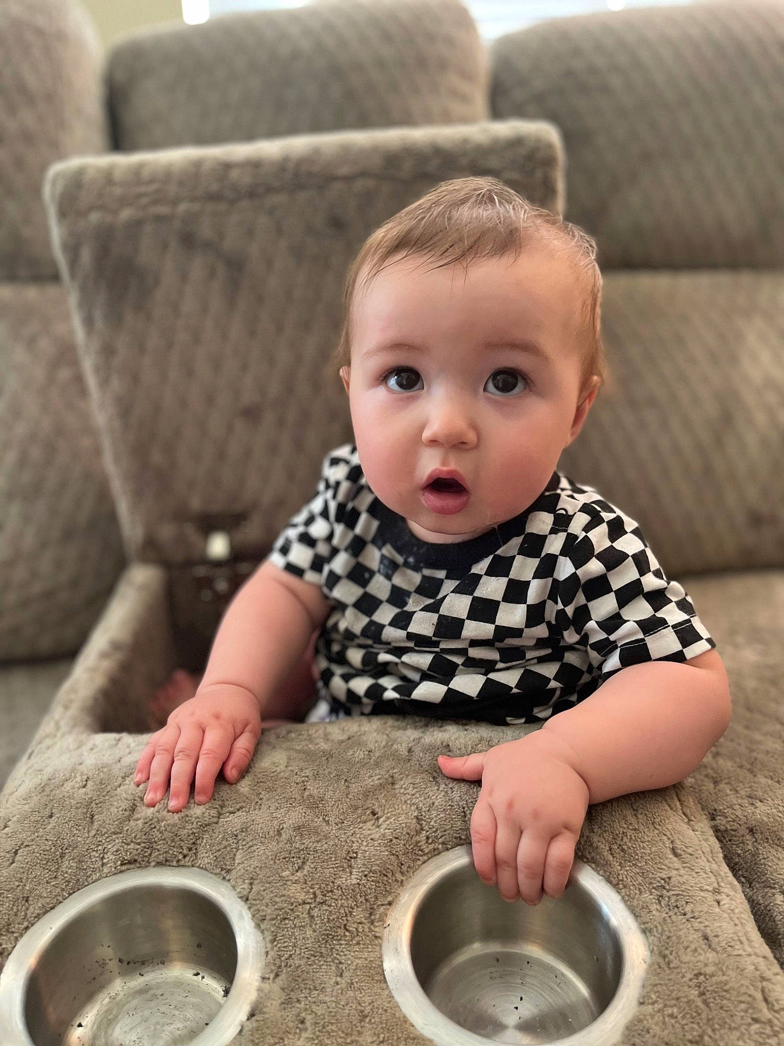 Caspian is registered to the contest to win money with this photo: automotive_tire, automotive_wheel_system, baby, baby_toddler_clothing, cheek, child, circle, comfort, composite_material, couch, flooring, pattern, person, photograph, sitting, sleeve, soil, surprise, t_shirt, toddler