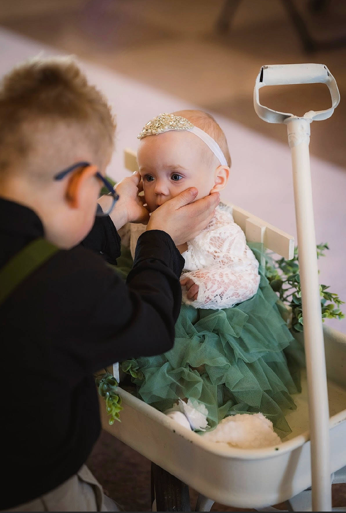 Serafina is registered to the contest to win money with this photo: baby, baby_toddler_clothing, bridal_clothing, child, dress, event, formal_wear, fun, gesture, glasses, goggles, happy, hat, headpiece, person, room, sitting, skin, standing, toddler