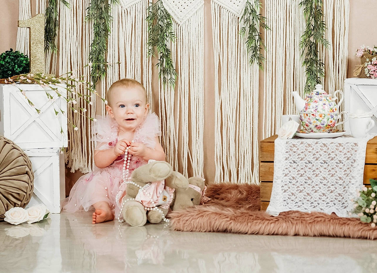 Serafina joined the competition — help win amazing prizes! baby, baby_toddler_clothing, child, comfort, dress, event, flooring, grass, happy, hardwood, home, houseplant, person, plant, room, sitting, smile, textile, toddler, tree