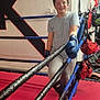 James joined the competition — help win amazing prizes! child, boxing_gloves, boxing_ring, sport, young_boy, smiling, training_equipment, casual_pose, indoor, red_floor, blue_gloves, protective_gear, boxing_socks, wall_art, fitness, exercise, athlete, sporty, happy, recreation