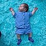baby, blue_outfit, child, cozy, cute, fluffy_rug, indoor, infant, lying_down, peaceful, person, portrait, relaxed, shirt, shorts, sleeping, socks, soft_texture, striped_socks, turquoise