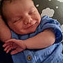 arm, baby, blue_clothing, button, child, cloud_pattern, comfort, cute, face, hand, indoor, infant, newborn, peaceful, pillow, portrait, resting, skin, sleeping, smile