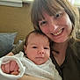 Orlando is registered to the contest to win money with this photo: baby, woman, smile, face, indoor, person, holding, couch, cushion, clothing, portrait, happy, infant, parent, family, skin, head, hand, long_hair, casual
