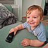 Orlando joined the competition — help win amazing prizes! toddler, child, smiling, toy_car, blue_eyes, short_hair, couch, blanket, indoor, radiator, happy, casual_clothing, playful, home, person, young_child, smile, hand, furniture, relaxation