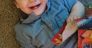 Orlando joined the competition — help win amazing prizes! toddler, child, smiling, blue_shirt, carpet, blanket, patchwork, happy, indoor, cute, baby, face, portrait, sitting, hand, toy, cozy, young_child, infant, playful