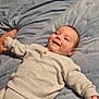 Orlando joined the competition — help win amazing prizes! baby, infant, smile, knitted_clothing, blanket, hand_holding, lying_down, cozy, cute, child, portrait, soft_texture, warm_clothing, happy, bedroom, resting, indoors, person, young_child, casual