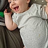 Orlando is registered to the contest to win money with this photo: apparel, baby, child, cloud_pattern, cute, expression, face, hand, happy, indoor, infant, lying_down, onesie, people, pillow, portrait, skin, smiling, toddler, young