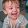 toddler, child, laughing, smiling, face, portrait, indoors, striped_shirt, brown_hair, blue_eyes, teeth, happy, seated, close_up, toy, playroom, home, photograph, joyful, baby