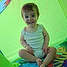 toddler, child, baby, smiling, happy, portrait, sitting, cross_legged, play_tent, indoor, colorful, green, play_mat, cartoon, toy, romper, barefoot, face, camera, family_photo