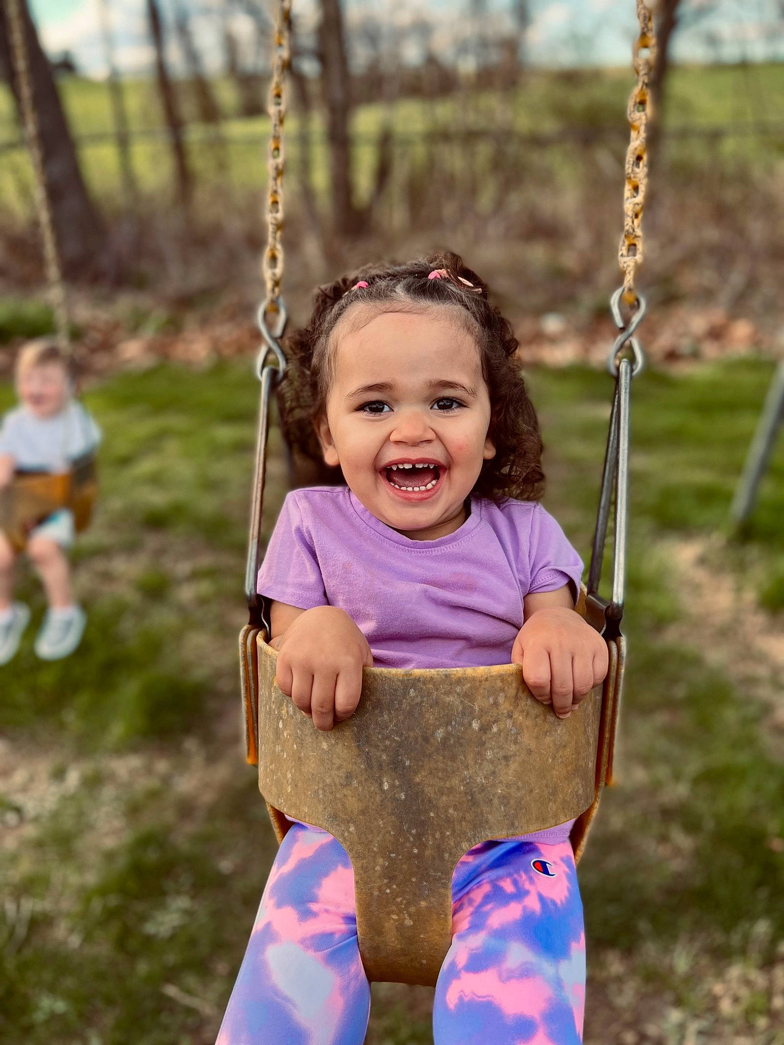 Haisley Mae joined the competition — help win amazing prizes! baby_toddler_clothing, clothing, eye, face, facial_expression, grass, hair, happy, head, human_body, leaf, people_in_nature, person, photograph, plant, playground, smile, swing, toddler, tree