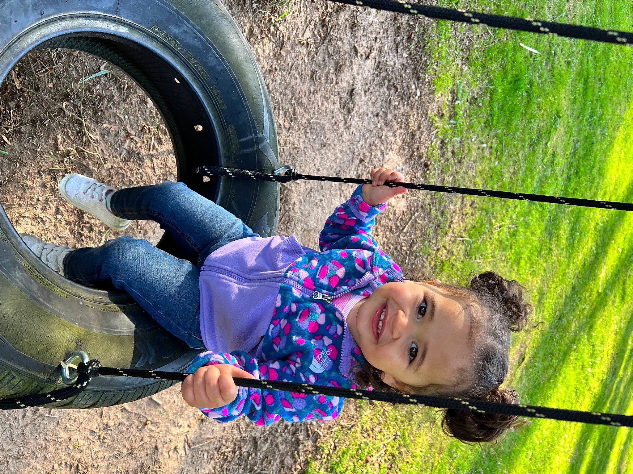 Haisley Mae is registered to the contest to win money with this photo: automotive_tire, bicycle_tire, electric_blue, fun, grass, happy, joy, leisure, nature, people, people_in_nature, person, photograph, recreation, smile, snapshot, swing, synthetic_rubber, tire, toddler