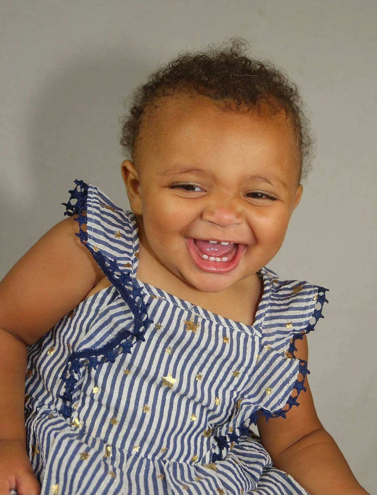 Kalliyah is registered to the contest to win money with this photo: arm, baby_toddler_clothing, cheek, chin, eye, eyelash, face, finger, forehead, gesture, happy, human_body, iris, joy, lip, neck, nose, person, skin, sleeve