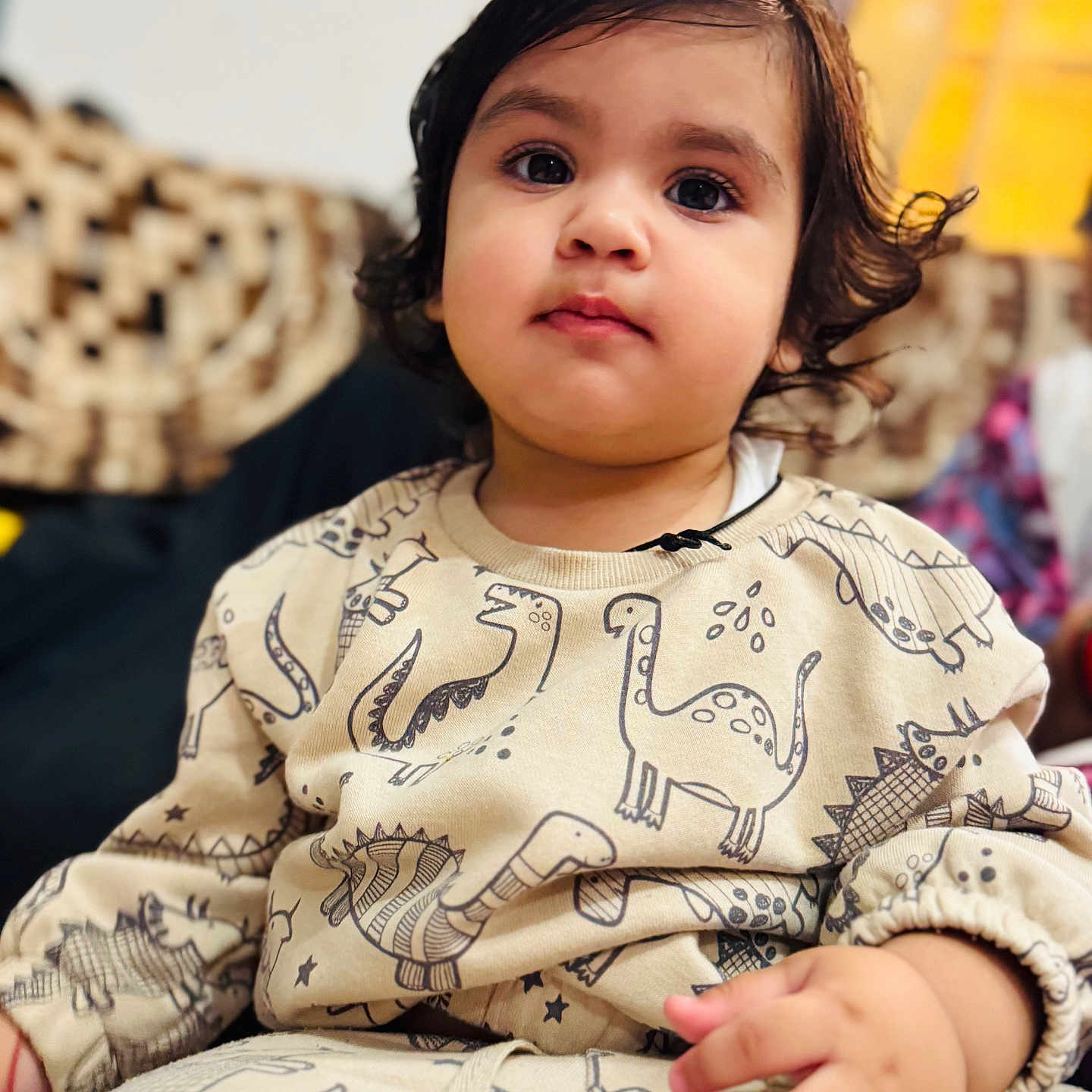 Kevika is registered to the contest to win money with this photo: casual, child, clothing, cozy, curly_hair, cute, dinosaur_print, expression, face, hair, hand, indoors, patterned_clothes, person, portrait, sitting, soft_lighting, toddler, young, young_child
