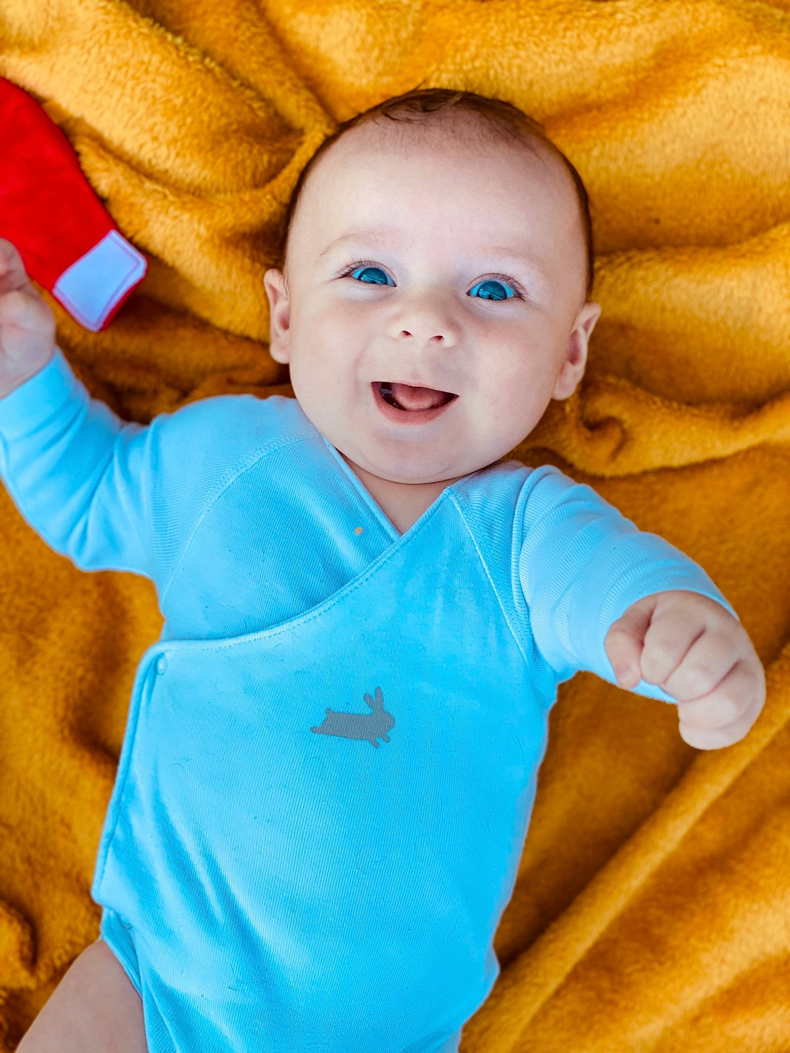 Aaron participe au concours pour gagner de l'argent avec cette photo : azure, baby, baby_toddler_clothing, cheek, chin, eye, gesture, happy, human_body, iris, mouth, nose, orange, organ, outerwear, person, product, skin, sleeve, smile