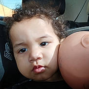 Amiracle joined the competition — help win amazing prizes! toddler, child, car_seat, curly_hair, doll, doll_head, face, portrait, indoors, seat, window, light, shadow, person, baby, expression, headrest, skin, closeup, young_child