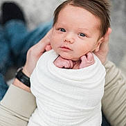 Ty joined the competition — help win amazing prizes! baby, newborn, infant, wrapped, blanket, hands, adult, face, portrait, blue_eyes, cute, soft_focus, skin, peaceful, small_fingers, close_up, human, child, tender, gentle