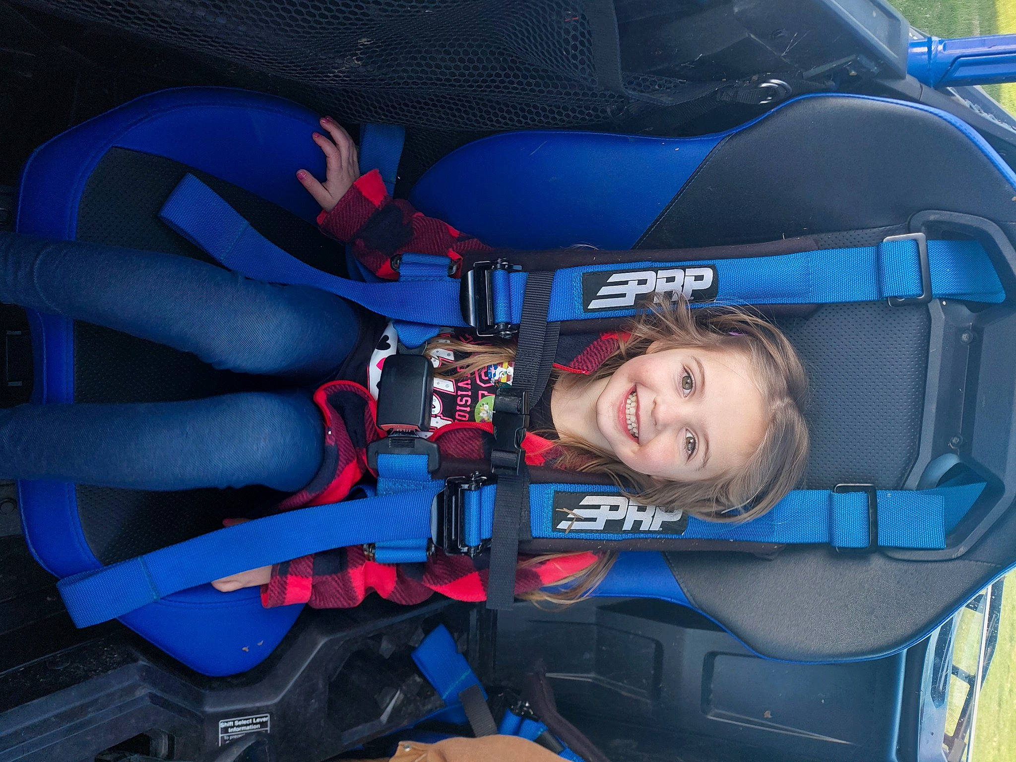 Macie is registered to the contest to win money with this photo: auto_part, automotive_design, automotive_exterior, automotive_tire, automotive_wheel_system, car_seat, carmine, electric_blue, family_car, fun, helmet, joy, leisure, motor_vehicle, person, personal_protective_equipment, recreation, smile, tire, toddler