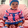 baby, child, crochet, hat, dress, booties, pink, blue, blanket, sitting, cute, portrait, indoors, soft_texture, warm_clothing, knitted, infant, expression, face, person