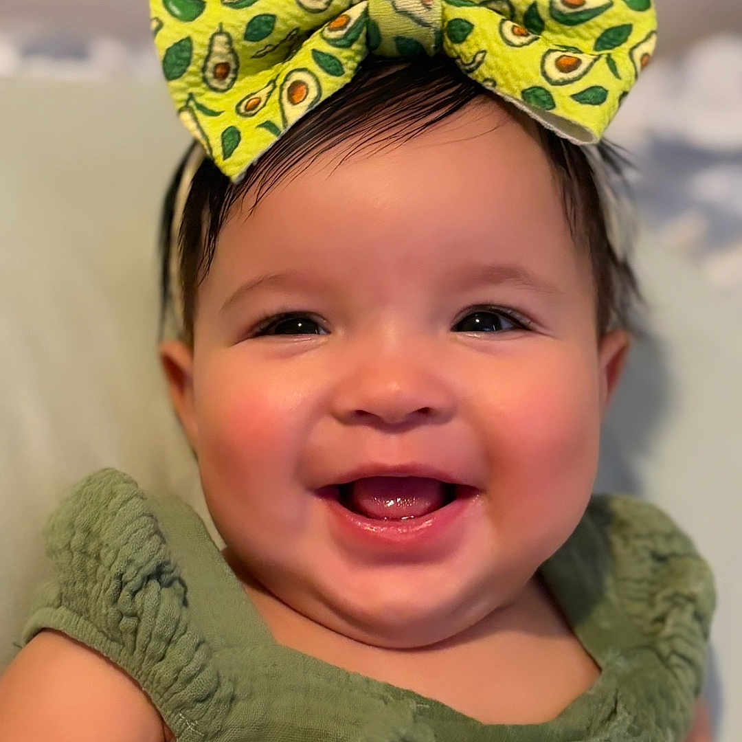 Yareyshka is registered to the contest to win money with this photo: accessory, baby, bow, cheerful, child, close_up, clothing, cute, face, fashion, green_dress, happy, headband, indoors, infant, person, portrait, skin, smiling, young