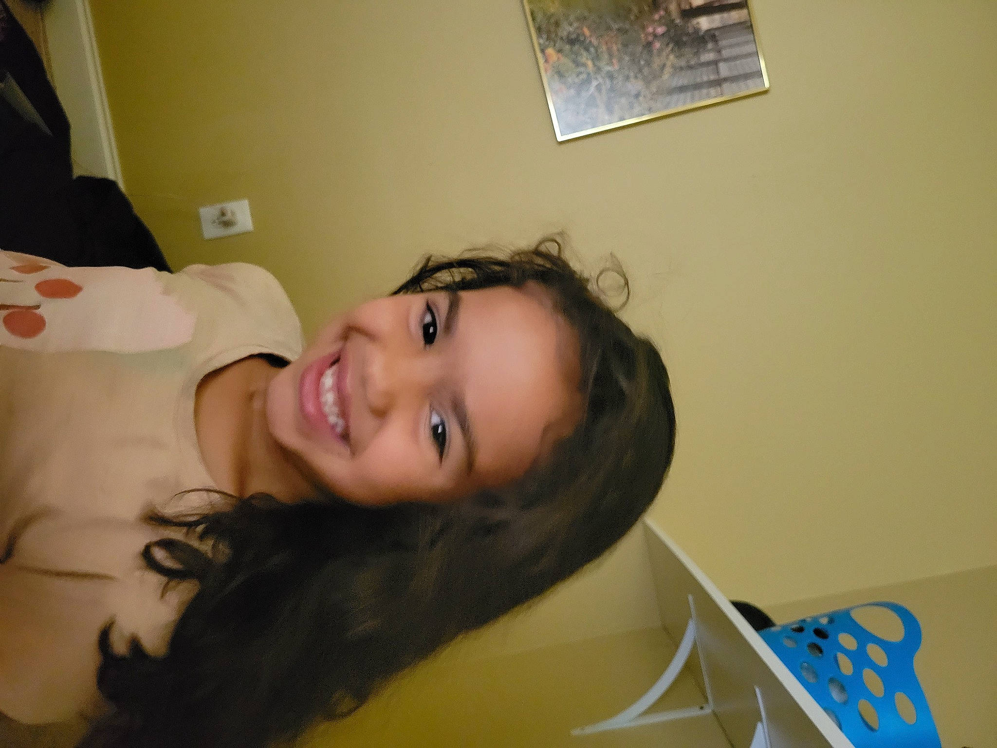 Briella is registered to the contest to win money with this photo: black_hair, child, comfort, eyebrow, eyelash, fun, hair, happy, jaw, joy, long_hair, neck, nose, person, picture_frame, room, sitting, skin, smile, vacation