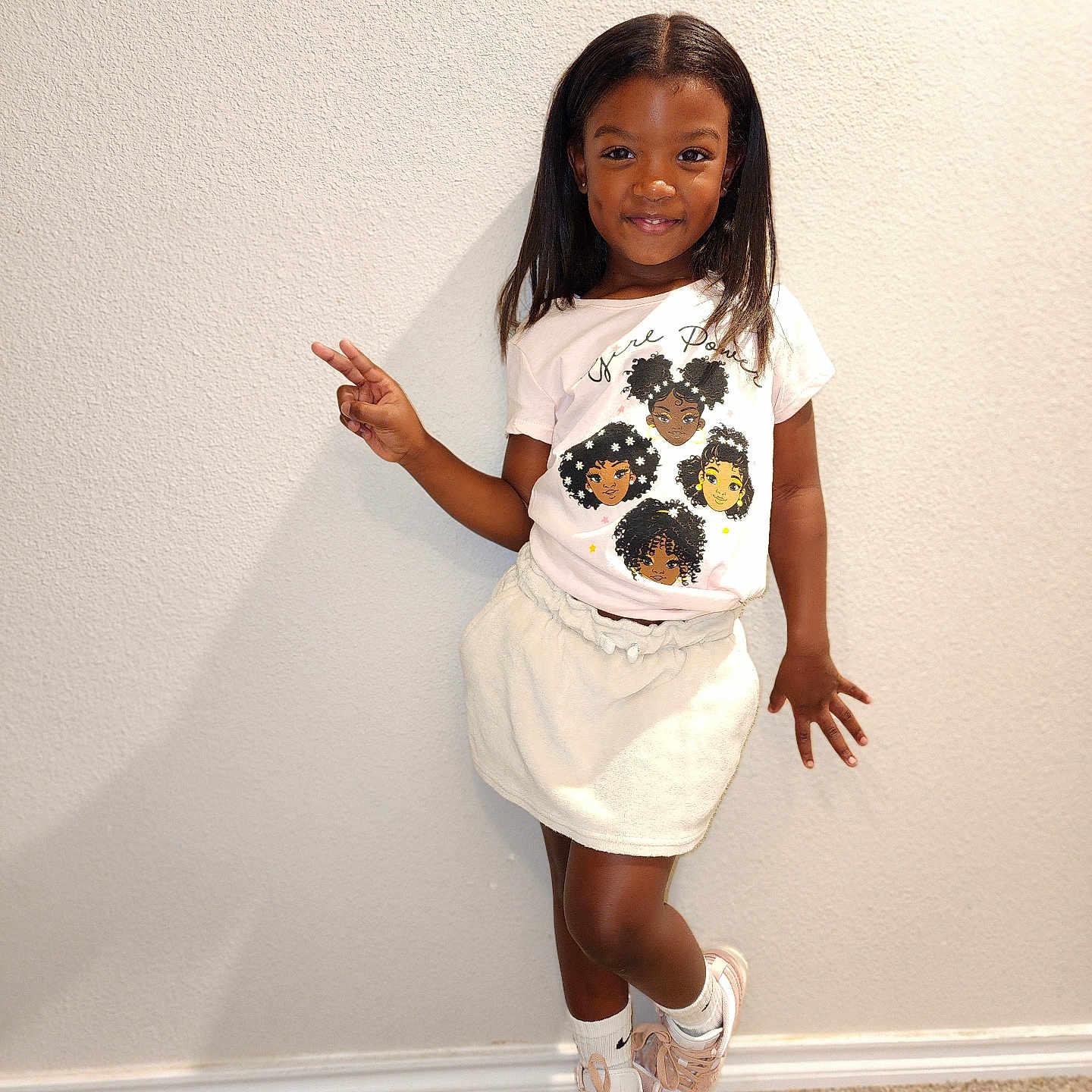 Kha'Lani is registered to the contest to win money with this photo: bodypart, child, clothing, face, female, finger, footwear, girl, hand, head, person, photography, portrait, sandal, shoe, shorts, skirt, sleeve, sneaker, t_shirt