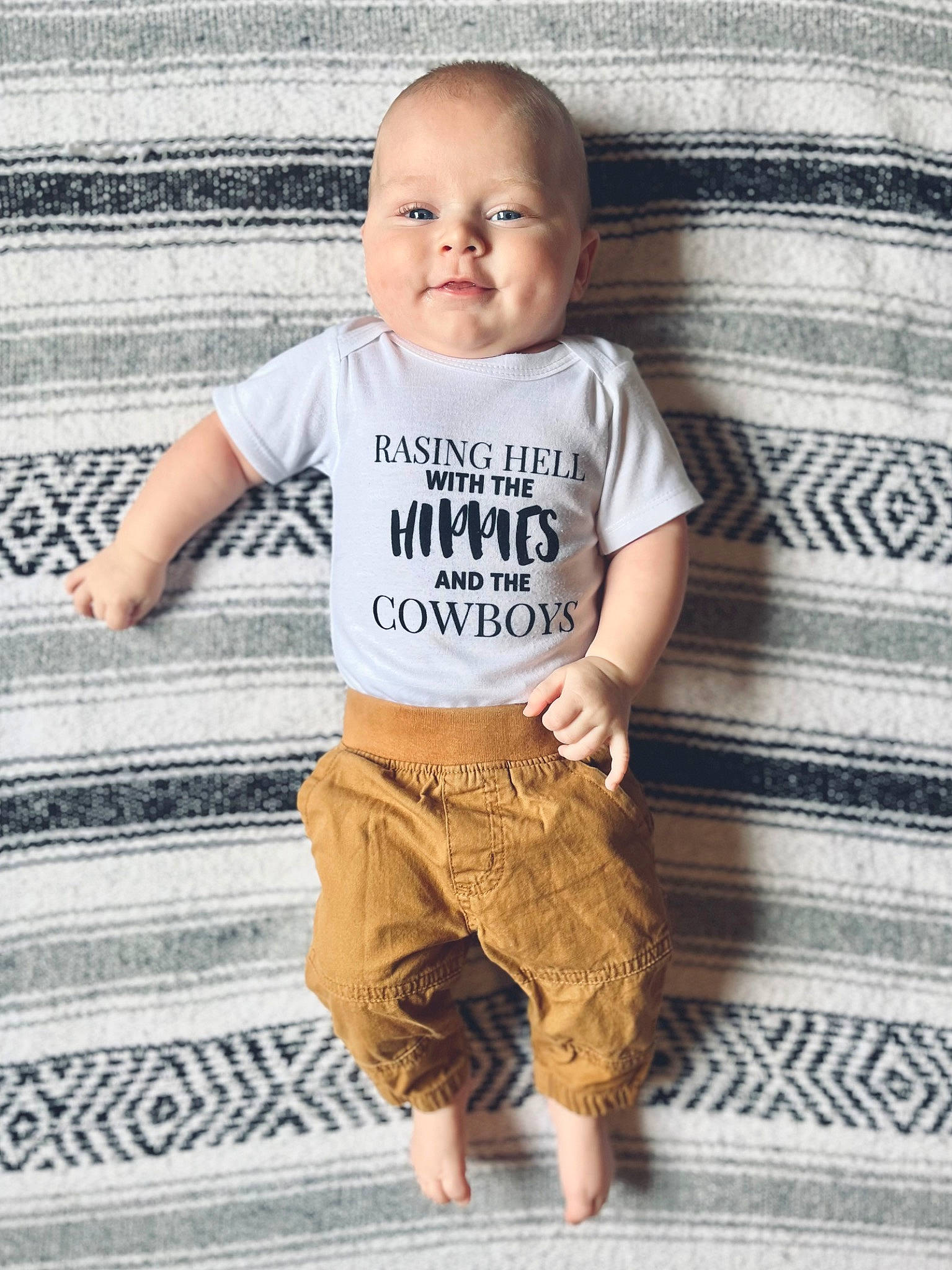 Huxton joined the competition — help win amazing prizes! baby, baby_toddler_clothing, child, cool, floor, flooring, grey, happy, khaki_pants, pajamas, pattern, person, photograph, sitting, sleeve, smile, t_shirt, toddler, top, waist