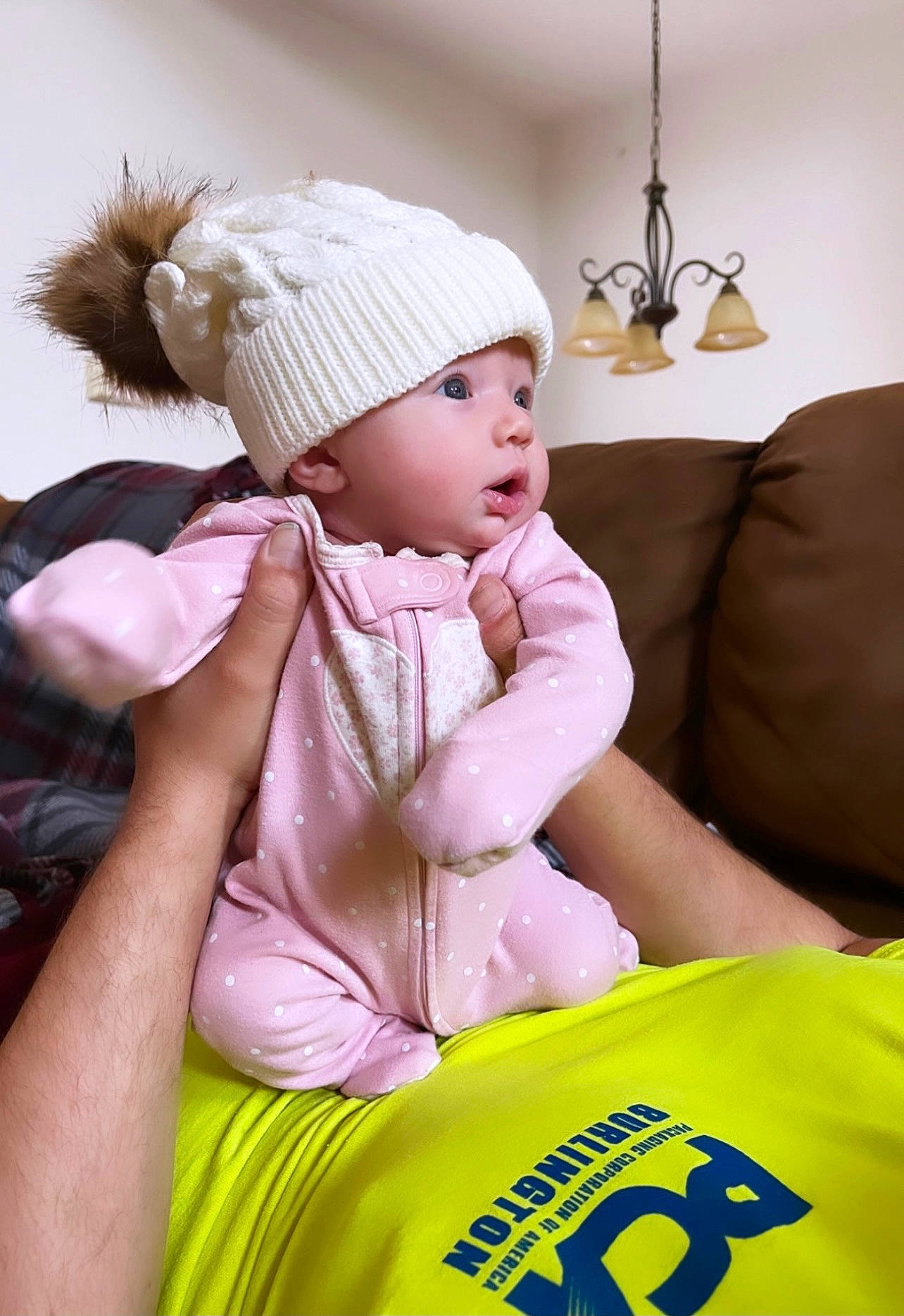 Margaret is registered to the contest to win money with this photo: baby, baby_toddler_clothing, cap, child, comfort, couch, event, fun, happy, headwear, knit_cap, lamp, leisure, logo, magenta, person, recreation, sitting, skin, t_shirt