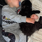 Luna is registered to the contest to win money with this photo: baby, child, sleeping, pacifier, cat, black_cat, couch, blanket, cozy, toddler, comfort, indoor, clothing, cute, rest, nap, furry, hug, relaxation, soft