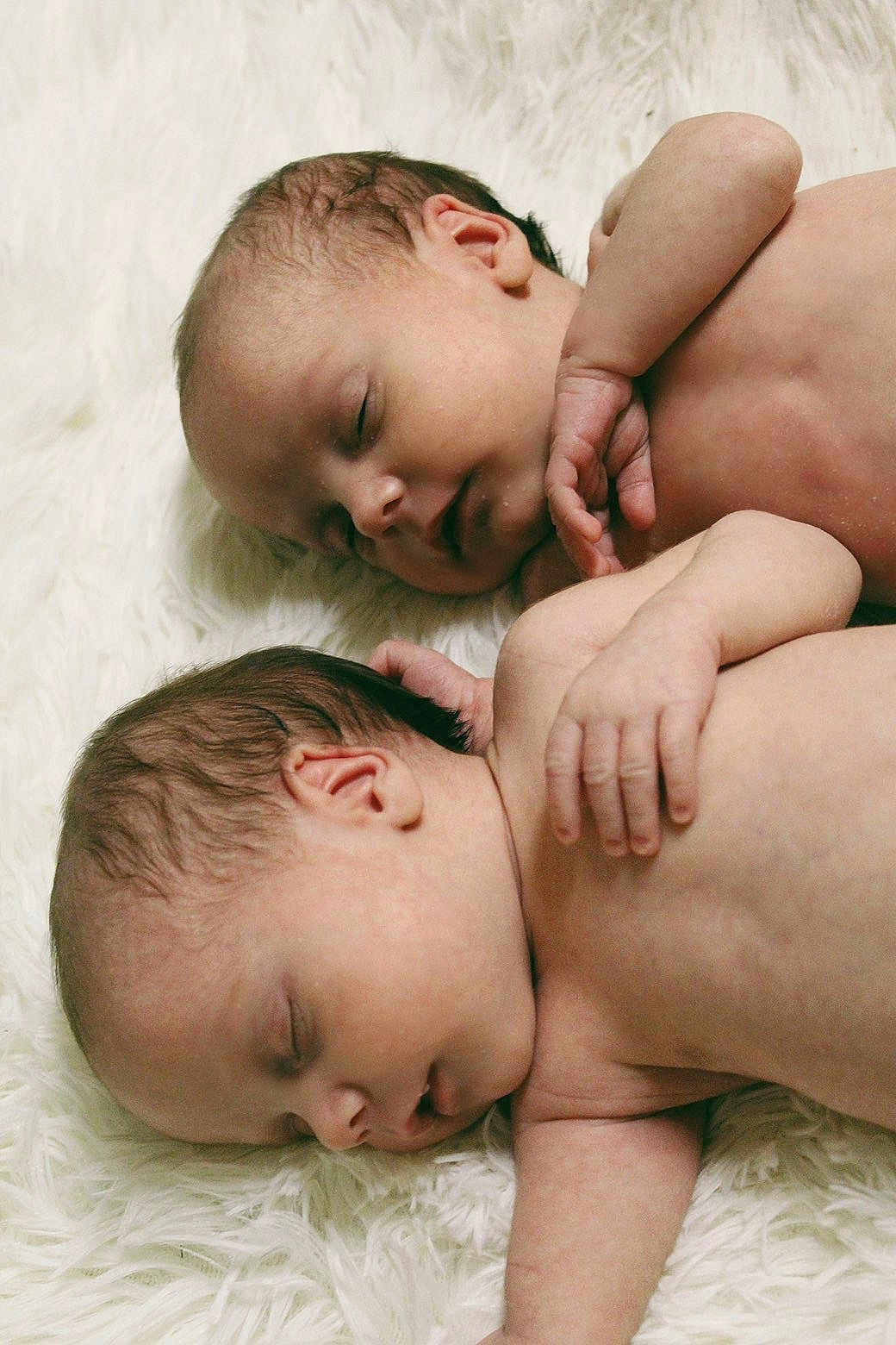 Paisley And Oakley is registered to the contest to win money with this photo: baby, newborn, infant, twin_babies, sleeping, naked, skin, hand, ear, face, portrait, close_up, white_blanket, soft_texture, resting, sibling, cute, peaceful, sleep, nursery