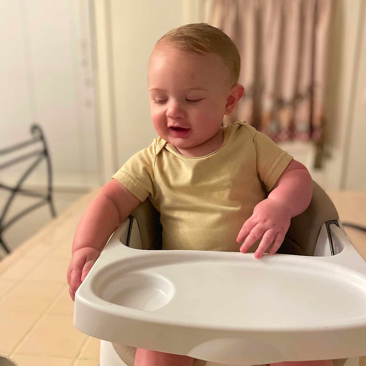 Christopher is registered to the contest to win money with this photo: toddler, child, high_chair, yellow_shirt, yellow_socks, indoor, kitchen, curtains, table, metal_chair, baby, person, seated, furniture, home, cute, expression, short_hair, footwear, infant