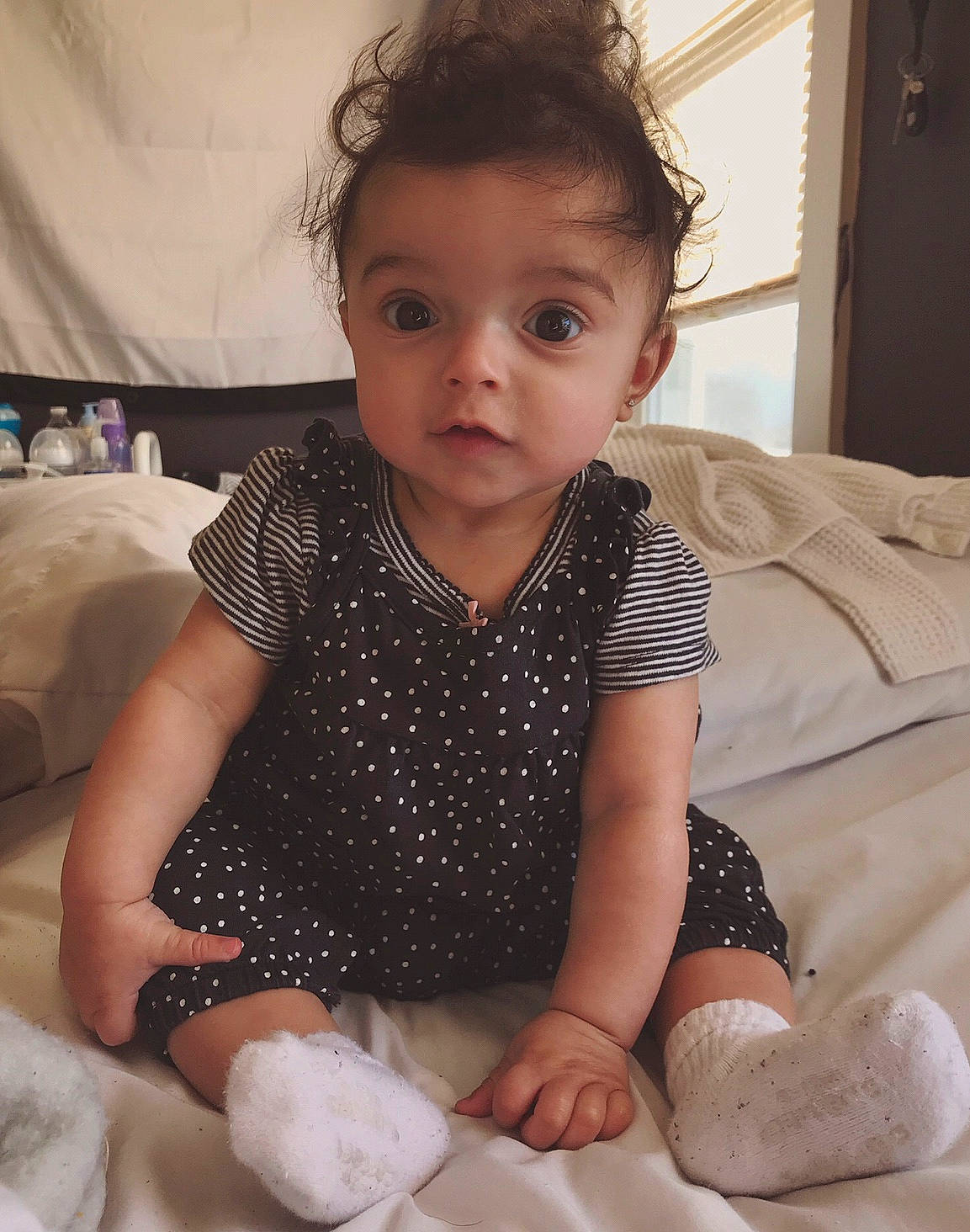 Maliah is registered to the contest to win money with this photo: baby, baby_toddler_clothing, cheek, child, eye, face, finger, hand, head, leg, nose, person, sitting, skin, sleeve, smile, toddler