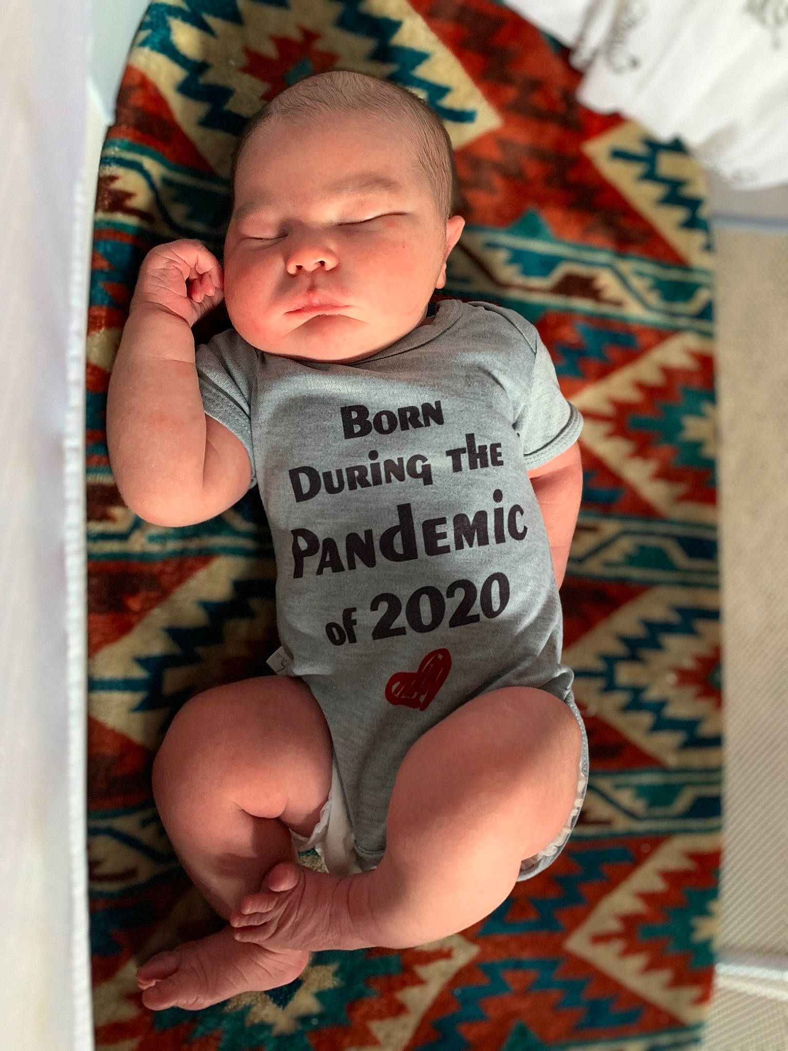 Desmond is registered to the contest to win money with this photo: arm, baby, baby_products, baby_toddler_clothing, child, leg, product, sitting, sleeve, smile, t_shirt, toddler