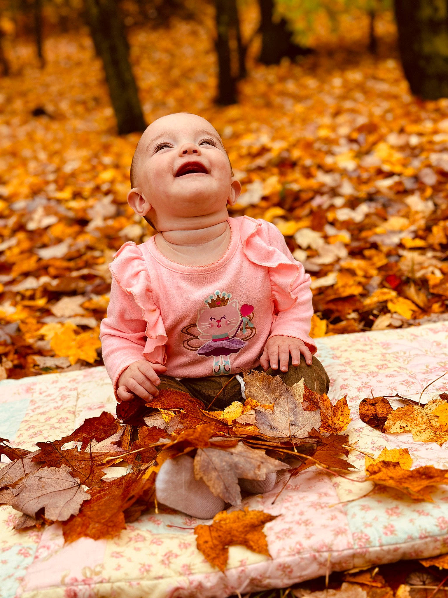 Lilah joined the competition — help win amazing prizes! autumn, baby, child, deciduous, forest, grass, happy, leaf, leisure, people_in_nature, person, plant, portrait_photography, sitting, smile, sunlight, toddler, tree, trunk, wood
