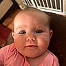 Meadow Rose joined the competition — help win amazing prizes! baby, child, face, portrait, pink_shirt, indoor, curious, wide_eyes, chubby_cheeks, person, infant, home, baby_gate, furniture, closeup, head, skin, expression, young, cute