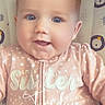 baby, baby_girl, baby_seat, blue_eyes, child, childrens_clothing, closeup, cute, face, happy, indoor, infant, lion_pattern, onesie, pink_clothing, portrait, sitting, smiling, soft_lighting, young_child