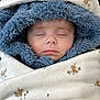 baby, sleeping, hood, blanket, fur, blue, white, face, child, cozy, cute, infant, closed_eyes, soft, warm, clothing, portrait, rest, comfort, animal_print